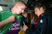 31 August 2006; Kevin Doyle, Republic of Ireland, signs an autograph on a supporter wearing a Wexford jersey prior to his departure to Stuttgart for the Euro 2008 Championship Qualifier against Germany. Dublin Airport, Dublin. Picture credit: David Maher / SPORTSFILE