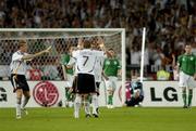 2 September 2006; Germany's Bastian Schweinsteiger, 7, congratulates team-mate Lukas Podolski, hidden, after he scored Germany's first goal from a free kick. Euro 2008 Championship Qualifier, Germany  v Republic of Ireland, Gottleib-Damlier Stadion, Stuttgart, Germany. Picture credit: Brian Lawless / SPORTSFILE
