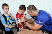 23 July 2014; Theo Adams, aged 6, from Portlaoise, Co. Laois, has his jersey signed by Leinster's Rhys Ruddock as Fionn O'Neill, aged 6, waits his turn, during The Herald Leinster Rugby Summer Camps in Portlaoise RFC, Co. Laois. Picture credit: Barry Cregg / SPORTSFILE