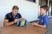 23 July 2014; Josh Bennett, aged 7, from Portlaoise, Co. Laois, has his rugby ball signed by Leinster's Ian Madigan during The Herald Leinster Rugby Summer Camps in Portlaoise RFC, Co. Laois. Picture credit: Barry Cregg / SPORTSFILE