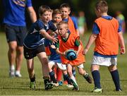 23 July 2014; Dylan Browne, centre, aged 8, in action against, Alex Mullins, left, aged 8, and Cathal Kenny, right, aged 9, during a mini-game at The Herald Leinster Rugby Summer Camps in Portlaoise RFC, Co. Laois. Picture credit: Barry Cregg / SPORTSFILE