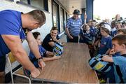 23 July 2014; Evan Brophy, aged 7, from Portlaoise, Co. Laois, helps answers questions for Leinster's Rhys Ruddock and Ian Madigan during The Herald Leinster Rugby Summer Camps in Portlaoise RFC, Co. Laois. Picture credit: Barry Cregg / SPORTSFILE