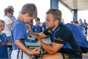 23 July 2014; Billy O'Sullivan, aged 8, from Ballyroan, Co. Laois, has his jersey signed by Leinster's Ian Madigan during The Herald Leinster Rugby Summer Camps in Portlaoise RFC, Co. Laois. Picture credit: Barry Cregg / SPORTSFILE