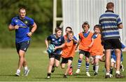 23 July 2014; Leinster's Rhy Ruddock looks on as Alex Mullins, aged 8, makes a break during a mini-game at The Herald Leinster Rugby Summer Camps in Portlaoise RFC, Co. Laois. Picture credit: Barry Cregg / SPORTSFILE