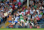 22 July 2014; Barry Nash, Limerick, shoots to score a point despite pressure from Peter Hogan, Waterford. Electric Ireland Munster GAA Hurling Minor Championship Final Replay, Waterford v Limerick, Semple Stadium, Thurles, Co. Tipperary. Picture credit: Diarmuid Greene / SPORTSFILE