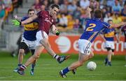 26 July 2014; Fontáin Ó Curraoin, Galway, shoots to score his side's first goal of the game despite the attempts of Robbie Kiely, left, and John Coghlan, Tipperary. GAA Football All Ireland Senior Championship, Round 4A, Galway v Tipperary. O'Connor Park, Tullamore, Co. Offaly. Picture credit: Barry Cregg / SPORTSFILE