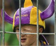 27 July 2014; Wexford supporter Jimmy Connors, age 8, from Clonroche, keeps an eye on the game. GAA Hurling All Ireland Senior Championship Quarter-Final, Limerick v Wexford. Semple Stadium, Thurles, Co. Tipperary. Picture credit: Ray McManus / SPORTSFILE