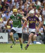 27 July 2014; David Breen, Limerick, on his way to scoring his side's first goal despite the efforts of Ciaran Kenny, Wexford. GAA Hurling All Ireland Senior Championship Quarter-Final, Limerick v Wexford. Semple Stadium, Thurles, Co. Tipperary. Picture credit: Diarmuid Greene / SPORTSFILE