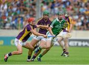 27 July 2014; Thomas Ryan, Limerick, in action against Lee Chin, left, and Richie Kehoe, Wexford. GAA Hurling All Ireland Senior Championship Quarter-Final, Limerick v Wexford. Semple Stadium, Thurles, Co. Tipperary. Picture credit: Dáire Brennan / SPORTSFILE