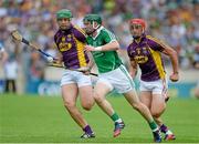27 July 2014; Thomas Ryan, Limerick, in action against Lee Chin, left, and Richie Kehoe, Wexford. GAA Hurling All Ireland Senior Championship Quarter-Final, Limerick v Wexford. Semple Stadium, Thurles, Co. Tipperary. Picture credit: Dáire Brennan / SPORTSFILE