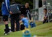 27 July 2014; Mark Langtry, UCD, is treated for an injury as manager Aaron O'Callaghan, right, looks on. SSE Airtricity League Premier Division, UCD v Derry City. The UCD Bowl, UCD, Belfield, Dublin. Picture credit: Piaras Ó Mídheach / SPORTSFILE