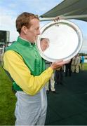 28 July 2014; Jockey Steven Clements with the winners trophy after he rode Quick Jack to win the Connacht Hotel (Q.R.) Handicap. Galway Racing Festival, Ballybrit, Co. Galway. Picture credit: Barry Cregg / SPORTSFILE