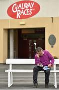29 July 2014; Tim O'Connor, from Tralee, Co. Kerry, looks up the form ahead of the day's races. Galway Racing Festival, Ballybrit, Co. Galway. Picture credit: Barry Cregg / SPORTSFILE