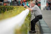 29 July 2014; A general view of a racegoer looking up the form ahead of the day's races. Galway Racing Festival, Ballybrit, Co. Galway. Picture credit: Barry Cregg / SPORTSFILE