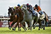 29 July 2014; Vastonea, right, with Gary Halpin up, comes to the finishing post ahead of Piri Wango, centre, with Colin Keane up, who finished second, and Defining Year, with Pat Smullen up, who finished fourth, to win the Topaz Mile Handicap. Galway Racing Festival, Ballybrit, Co. Galway. Picture credit: Barry Cregg / SPORTSFILE