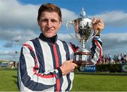29 July 2014; Jockey Gary Halpin with the winners trophy after he rode Vastonea to victory in the Topaz Mile Handicap. Galway Racing Festival, Ballybrit, Co. Galway. Picture credit: Barry Cregg / SPORTSFILE