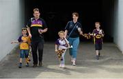 27 July 2014; The Cunniffe family, from left to right, Jamie, aged 7, dad Padraig, Aisling, aged 5, mam Marie and Aaron, aged 7, all from Monageer, Co. Wexford, make their way into the ground before the game. GAA Hurling All Ireland Senior Championship Quarter-Final, Limerick v Wexford. Semple Stadium, Thurles, Co. Tipperary. Picture credit: Diarmuid Greene / SPORTSFILE