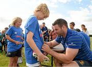 30 July 2014; Pierce McCarthy, aged 11, from Nurney, Co. Kildare, has his shirt signed by with Leinster and Ireland rugby player Fergus McFadden during the The Herald Leinster Rugby Summer Camps in Cill Dara RFC, Co. Kildare. Picture credit: Piaras Ó Mídheach / SPORTSFILE