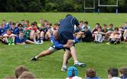30 July 2014; Coach Ben Armstrong demonstrates tackle technique to participants during a Leinster School of Excellence Camp. The King's Hospital, Palmerstown, Dublin. Picture credit: Brendan Moran / SPORTSFILE