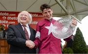 30 July 2014; Jockey Shane Shortall holds up the Galway Plate, as he is congratulated by The President of Ireland Michael D. Higgins, after he rode Road to Riches to win thetote.com Galway Plate. Galway Racing Festival, Ballybrit, Co. Galway. Picture credit: Barry Cregg / SPORTSFILE