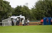 30 July 2014; Republic of Ireland manager Martin O'Neill, centre in grey suit, and his friend Justin Carthy, in beige overcoat, Head of Racecource Management for Ladbrokes and owner of Break My Mind, look on as jockey Sarah Lynam is attended to after Mr Carthy's horse had fallen in the Grab A Grand With Tote Maiden. Galway Racing Festival, Ballybrit, Co. Galway. Picture credit: Ray McManus / SPORTSFILE