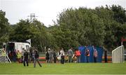 30 July 2014; Republic of Ireland manager Martin O'Neill, centre in grey suit, and his friend Justin Carthy, in beige overcoat, Head of Racecource Management for Ladbrokes and owner of Break My Mind, look on as jockey Sarah Lynam is attended to after Mr Carthy's horse had fallen in the Grab A Grand With Tote Maiden. Galway Racing Festival, Ballybrit, Co. Galway. Picture credit: Ray McManus / SPORTSFILE