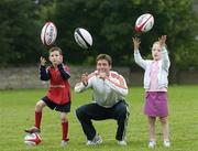 11 September 2006; Ronan O'Gara, with Rory Frankling, and Sara Fisher, who helped launch the second year of the Tesco Sport for Schools and Clubs Scheme. This major sporting initiative is aimed at inspiring Irelands children to get fitter and healtheir through emulating their sporting heroes, and learning to enjoy and get involved in sport. St Michaels College, Ailesbury Road, Dublin. Picture credit: David Maher / SPORTSFILE