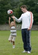 11 September 2006; Ronan O'Gara, with Ryan Spencer, aged 4, who helped launch the second year of the Tesco Sport for Schools and Clubs Scheme. This major sporting initiative is aimed at inspiring Irelands children to get fitter and healtheir through emulating their sporting heroes, and learning to enjoy and get involved in sport. St Michaels College, Ailesbury Road, Dublin. Picture credit: David Maher / SPORTSFILE