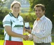 9 September 2006; Gillian Bennett, Meath, is presented with her medal by Bertrand Boisse, MBNA, after winning the ladies competition at the 2006 MBNA Kick Fada Final. Bray Emmets GAA Club, Bray, Co. Wicklow. Picture credit: Pat Murphy / SPORTSFILE