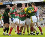 17 September 2006; Referee Brian Crowe tries his best to seperate David Brady, Mayo, and Declan O'Sullivan, Kerry. Bank of Ireland All-Ireland Senior Football Championship Final, Kerry v Mayo, Croke Park, Dublin. Picture credit: Ray McManus / SPORTSFILE
