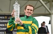 31 July 2014; Jockey Tony McCoy holds up the winning trophy after rode Thomas Edison to victory in the Guinness Galway Hurdle Handicap. Galway Racing Festival, Ballybrit, Co. Galway. Picture credit: Barry Cregg / SPORTSFILE