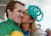31 July 2014; Jockey Tony McCoy receives a kiss from his wife Chanelle after he rode Thomas Edison to victory in the Guinness Galway Hurdle Handicap. Galway Racing Festival, Ballybrit, Co. Galway. Picture credit: Barry Cregg / SPORTSFILE