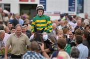 31 July 2014; Jockey Tony McCoy enters the parade ring, on Thomas Edison, after winning the Guinness Galway Hurdle Handicap. Galway Racing Festival, Ballybrit, Co. Galway. Picture credit: Ray McManus / SPORTSFILE