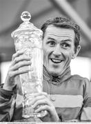 31 July 2014; (Editors please note; This black & white image has been created from an original colour file) Jockey Tony McCoy holds up the winning trophy after rode Thomas Edison to victory in the Guinness Galway Hurdle Handicap. Galway Racing Festival, Ballybrit, Co. Galway. Picture credit: Barry Cregg / SPORTSFILE