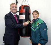 14 September 2006; John O'Donoghue, T.D., Minister for Arts, Sport and Tourism, admires Irish Boxer Katie Taylor's second Women's European Senior Championship goal medal at an announcement of the allocation of more than €2 million under the 'Women in Sport' initiative. This initiative has been developed to encourage girls and women into sport and supporting women's roles within sports organisations. Irishtown Athletic Stadium, Ringsend, Dublin. Picture credit: Damien Eagers / SPORTSFILE
