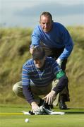 16 September 2006; David Scully, Galway G.C., and his caddie David Collins line up a putt on the seventh hole during the Bulmers Senior Cup Final. Bulmers Cups and Shields Finals 2006, Enniscrone Golf Club, Enniscrone, Sligo. Picture credit: Ray McManus / SPORTSFILE