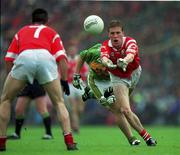 18 July 1999; Anthony Lynch passes the ball to his Cork team-mate Martin Cronin during the Bank of Ireland Munster Senior Football Championship Final between Cork and Kerry at Páirc Uí Chaoimh in Cork. Photo by Ray McManus/Sportsfile