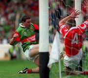 22 August 1999; Barry Loftus of Mayo scores his side's goal despite the effort of Finbarr Crowley of Cork during the All-Ireland Minor Football Championship Semi-Final match between Cork and Mayo at Croke Park in Dublin. Photo by Aoife Rice/Sportsfile