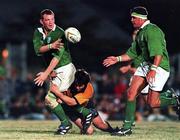 5 June 1999; David Corkery of Ireland gets the ball away to Dion O'Cuinneagain despite the tackle of Julian Moreton, New South Wales Country, during the Ireland Rugby tour to Australia match between New South Wales Country XV and Ireland at the Woy Woy Oval in New South Wales, Australia. Photo by Matt Browne/Sportsfile