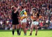 13 September 1998; Referee Dickie Murphy looks at the injury of Offaly's Johnny Dooley during the Guinness All-Ireland Senior Hurling Championship Final between Offaly and Kilkenny at Croke Park in Dublin. Photo by Ray McManus/Sportsfile