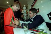 26 August 1999; Republic of Ireland striker Robbie Keane signs an autograph for Zack Eustace, age 10, during Robbie Keane's visit to Champion Sports in Dublin. Photo by David Maher/Sportsfile