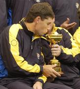 21 September 2006; Padraig Harrington, Team Europe 2006, kisses the Ryder Cup while team captain Ian Woosnam holds the trophy during the official team photocall. 36th Ryder Cup Matches, K Club, Straffan, Co. Kildare, Ireland. Picture credit: Damien Eagers / SPORTSFILE