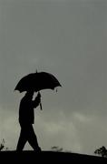 23 September 2006; A golf marshall takes shelter from the rain during Saturday morning's four-ball matches. 36th Ryder Cup Matches, K Club, Straffan, Co. Kildare, Ireland. Picture credit: Brendan Moran / SPORTSFILE