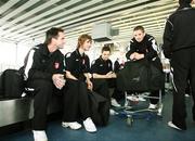 26 September 2006; Derry City players, from left, Darren Kelly, Pat McCourt, Kevin Deery, and Kevin McHugh, wait for their baggage at Charles De Gaulle Airport ahead of their UEFA Cup First Round, Second Leg, game against Paris St Germain. Charles De Gaulle Airport, Paris, France. Picture credit: Oliver McVeigh / SPORTSFILE