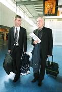 26 September 2006; Derry City manager Stephen Kenny in conversation with Edward Daly, retired Bishop of Derry, on their arrival at Charles De Gaulle Airport ahead of their UEFA Cup First Round, Second Leg, game against Paris St Germain. Charles De Gaulle Airport, Paris, France. Picture credit: Oliver McVeigh / SPORTSFILE