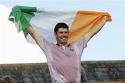 24 September 2006; Padraig Harrington, Team Europe 2006, celebrates with the tricolour on the balcony of the clubhouse after victory over the USA. 36th Ryder Cup Matches, K Club, Straffan, Co. Kildare, Ireland. Picture credit: Brendan Moran / SPORTSFILE