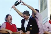24 September 2006; Lee Westwood, Team Europe 2006, pours champagne on team captain Ian Woosnam in the company of Dr Michael Smurfit on the balcony of the clubhouse after victory over the USA. 36th Ryder Cup Matches, K Club, Straffan, Co. Kildare, Ireland. Picture credit: Brendan Moran / SPORTSFILE