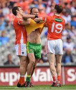 9 August 2014; Colm McFadden, Donegal, tussles with Brendan Donaghy, left, and Finnian Moriarty, Armagh. GAA Football All-Ireland Senior Championship, Quarter-Final, Donegal v Armagh, Croke Park, Dublin. Picture credit: Stephen McCarthy / SPORTSFILE