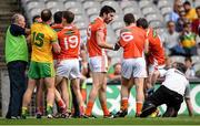 9 August 2014; Aaron Findon, Armagh, and Donegal team doctor Kevin Moran during an altercation in the first half. GAA Football All-Ireland Senior Championship, Quarter-Final, Donegal v Armagh, Croke Park, Dublin. Picture credit: Stephen McCarthy / SPORTSFILE