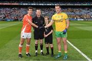 9 August 2014; Donegal captain Michael Murphy shakes hands with Armagh captain Jamie Clarke. with referee Joe McQuillan, and Dara McCarthy, aged 13, from Na Fianna GAA Club. GAA Football All-Ireland Senior Championship, Quarter-Final, Donegal v Armagh, Croke Park, Dublin. Picture credit: Ray McManus / SPORTSFILE